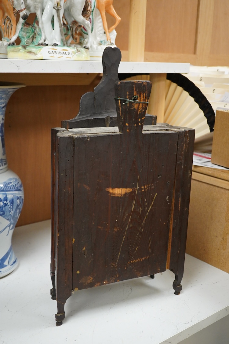 An 18th century French walnut candle box, modelled as a miniature armoire, carved with birds and flowers, 50cm high